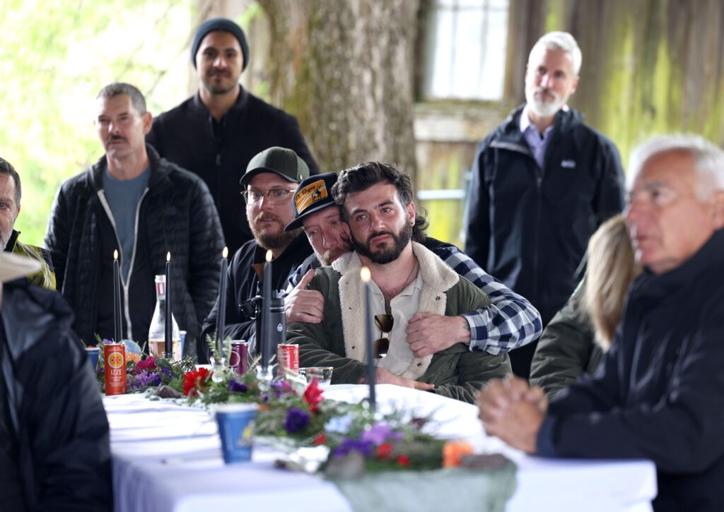 Ramses Pringle, brother of Katranne Pringle, is surrounded by friends during a celebration of life event remembering his sister at Tolay Lake Regional Park in Petaluma Sunday, March 30, 2025. (Beth Schlanker / The Press Democrat) 