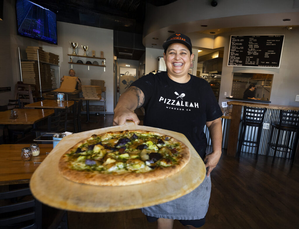 Leah Scurto, owner of PizzaLeah in Windsor, serves up one of her award winning pizzas. (John Burgess/The Press Democrat)