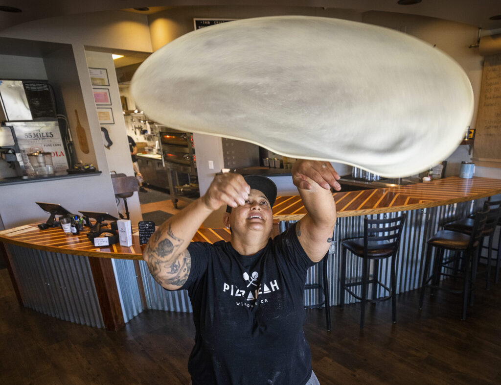 Leah Scurto, owner of PizzaLeah, tosses pizza dough in her Windsor restaurant Sept. 27, 2022. Scurto competed for best pizza maker on Hulu’s “Best in Dough,” streaming now. (John Burgess / The Press Democrat)
