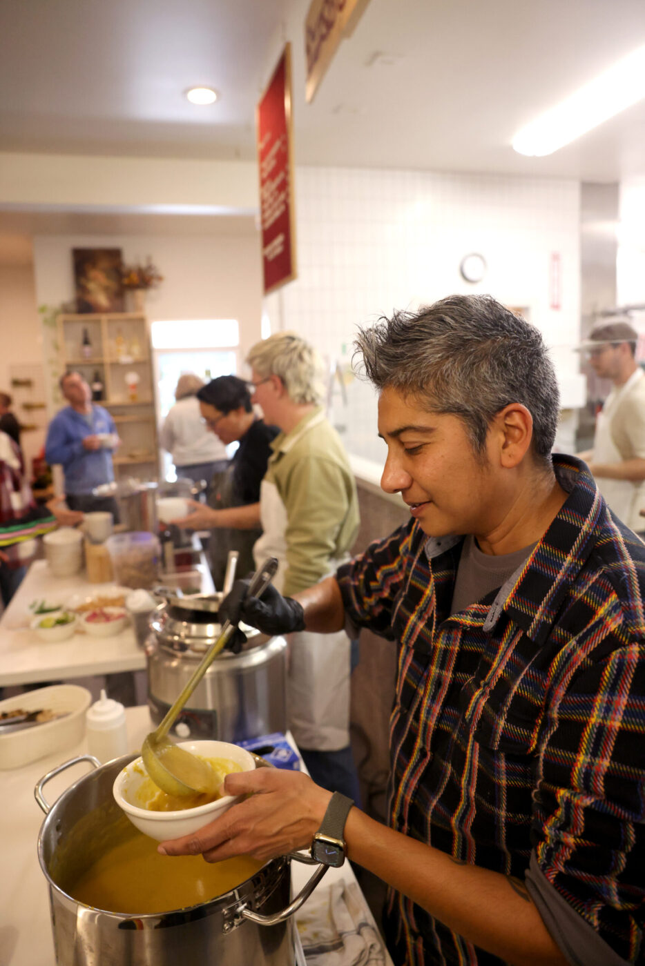 Chef Preeti Mistry serves up a butternut squash dal soup during the Queer Soup Night event at Slow Co. Pizza in Cotati Sunday, Nov. 23, 2025. (Beth Schlanker / The Press Democrat)