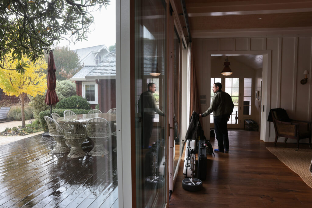 Michael Gay, tour manager for The Deslondes, looks out at the rain at Little Saint Farm in Healdsburg on Thursday, November 13, 2025. (Christopher Chung/The Press Democrat)