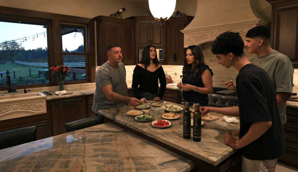 The Husary family, from left, Mousa, Talia, Yara, Jake and George, sample their Husary olive oils at their home, Wednesday, Nov. 26, 2025, near Graton. (Kent Porter / The Press Democrat)