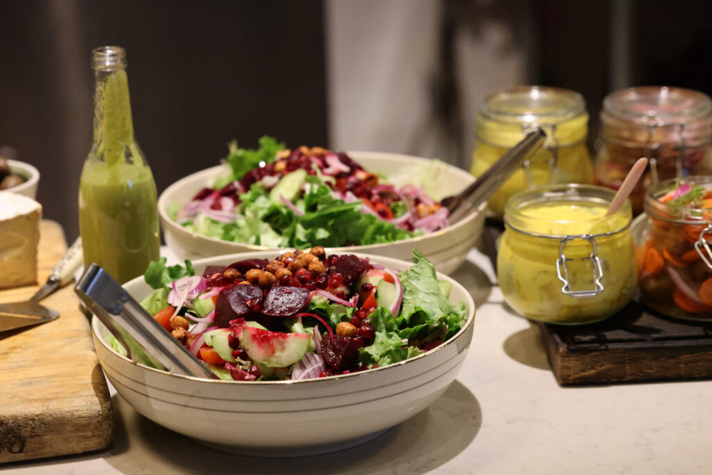 Mixed greens with beets, cucumber sliced red onion and garbanzo beans served during a holiday julbord at Stockhome in Petaluma Sunday, Dec. 14, 2025. (Beth Schlanker / The Press Democrat)