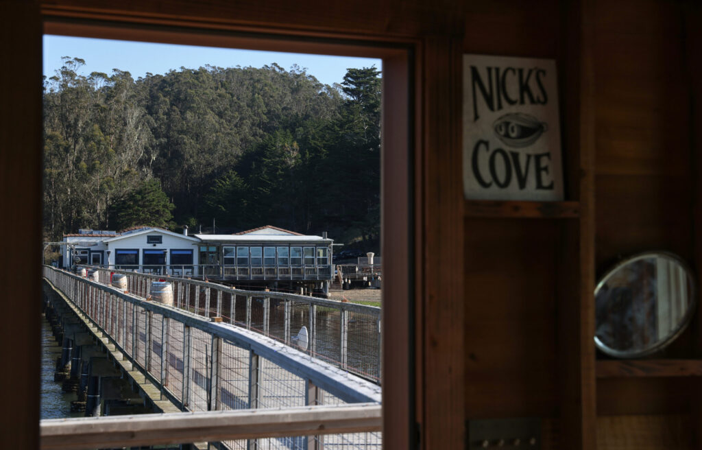 The restaurant at Nick’s Cove seen from the doorway of the newly reopened Boat Shack at the end of the pier in Marshall on Wednesday, December 10, 2025. (Christopher Chung/The Press Democrat)