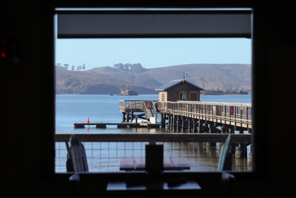 The Boat Shack at the end of the pier at Nick’s Cove seen from the dining room of the restaurant in Marshall on Wednesday, December 10, 2025. (Christopher Chung/The Press Democrat)