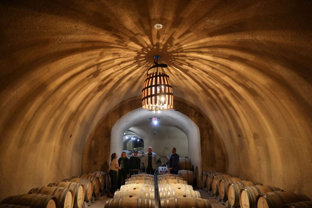 Hanzell Vineyards estate educator Ursula Ayala, left, leads Nancy Schroeder, Gustav Gustavsson, Ralph Schroeder, and Nicholas Schroeder, on a tour of the wine caves in Sonoma on Friday, November 7, 2025. (Christopher Chung/The Press Democrat)