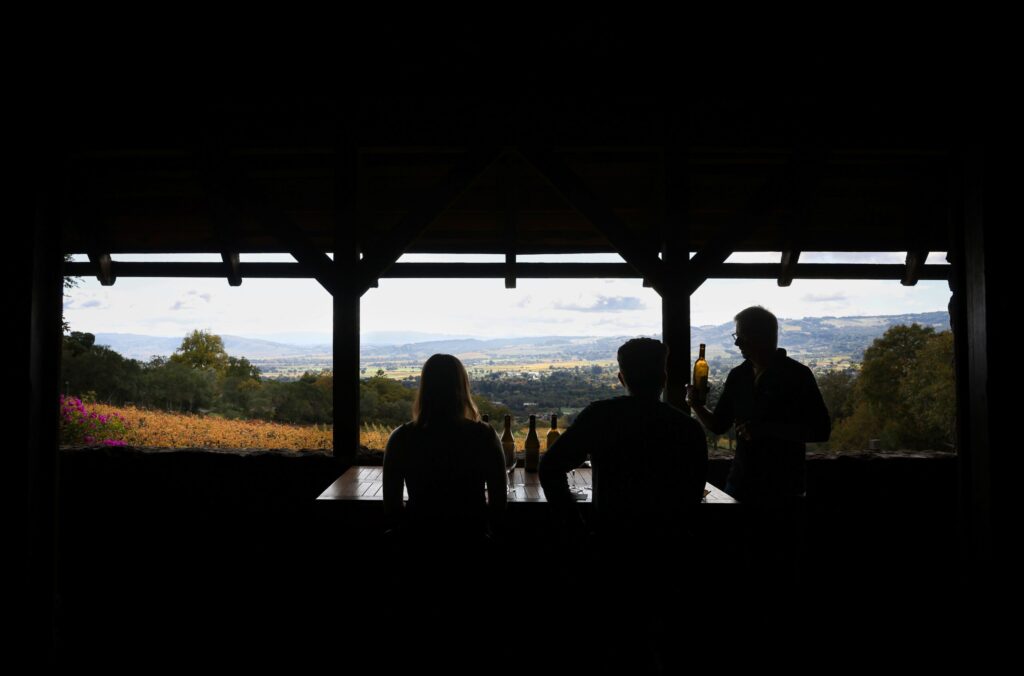 Winemaker Michael McNeill, right, talks about the wines at Hanzell Vineyards to visitors Drew and Bailey Sterioti during a tasting in Sonoma on Friday, November 7, 2025. (Christopher Chung/The Press Democrat)