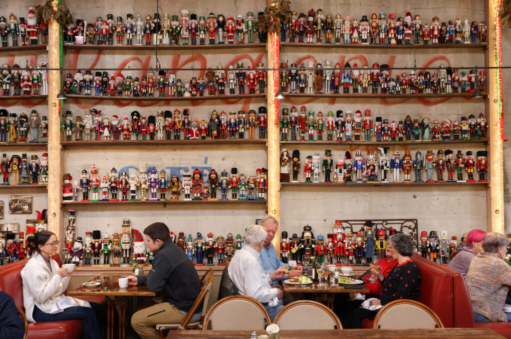 A wall full of nutcrackers on display over customers at Costeaux French Bakery in Healdsburg on Tuesday, December 9, 2025. (Christopher Chung/The Press Democrat)