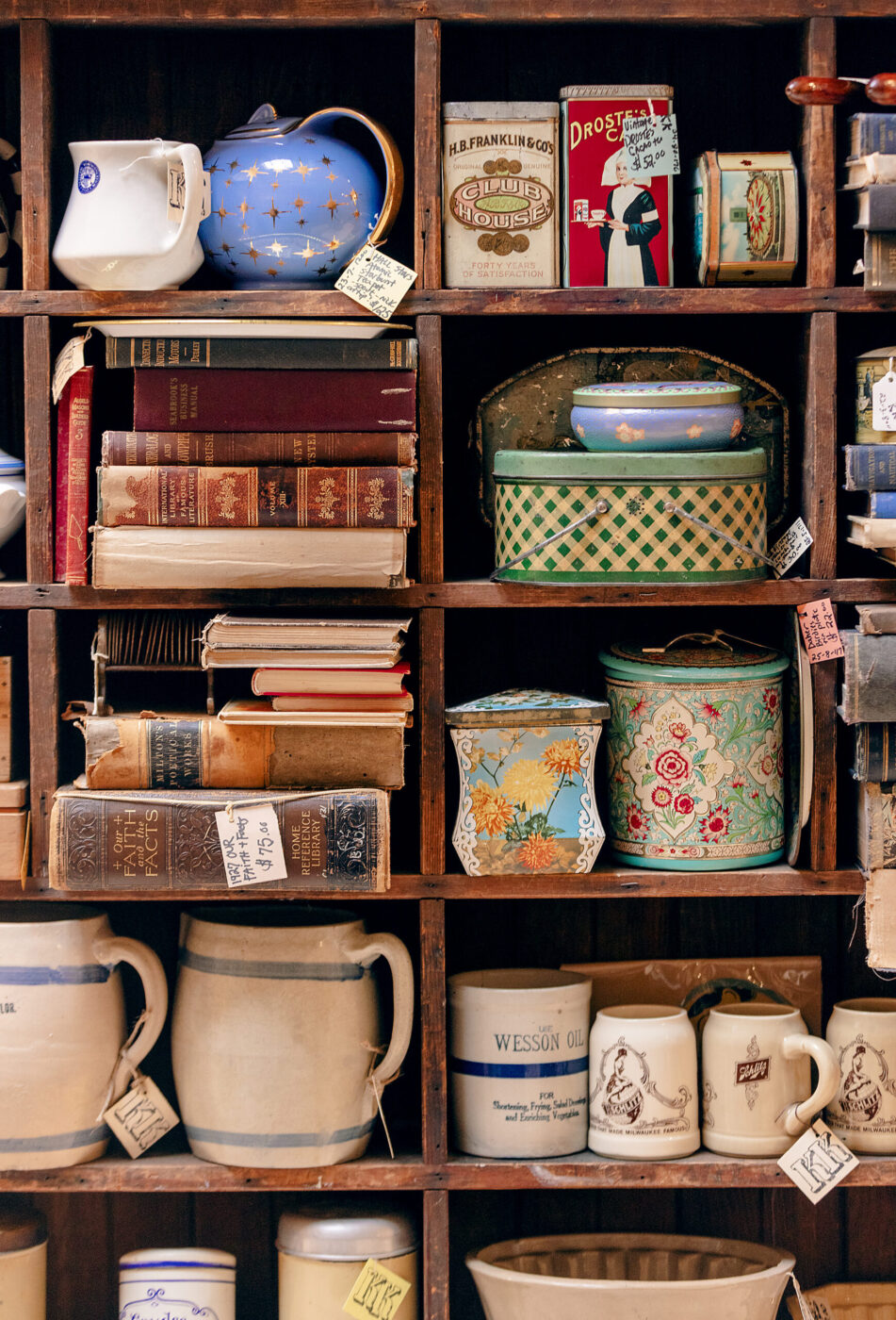 Antique tins and books from one of the many vendors inside the Antique Society Thursday, Oct. 2, 2025 in Sebastopol. (John Burgess / The Press Democrat)