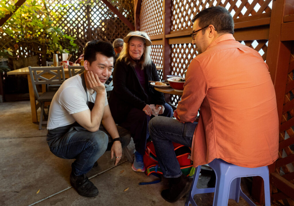 Bazaar Sonoma restaurant owner Sean Quan, left, talks with long-time supporter, Santa Rosa Symphony Music Director and Conductor Francesco Lecce-Chong Thursday, Oct. 16, 2025 and his mother Catherine at their new temporary location in Forestville. (John Burgess / The Press Democrat)