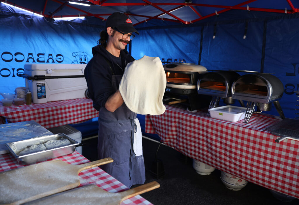 Jeremy Clemens stretches pizza dough at the Gabacool Provisions pop-up in Santa Rosa on Thursday, January 30, 2025. (Christopher Chung/The Press Democrat)