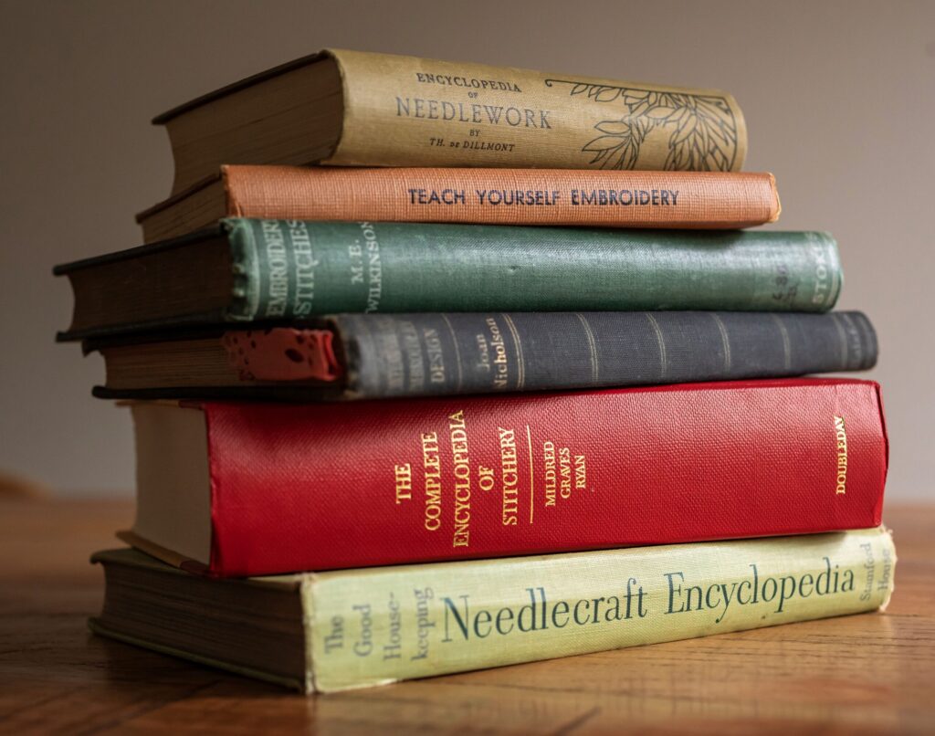 Two shelves of vintage books, including volumes on needlecraft, flank either side of Robert Mahar's studio door. (Chad Surmick / Sonoma Magazine)