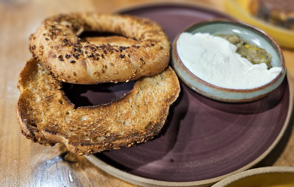Simit, a Turkish cousin to the bagel, is served with charred leek confit and cream cheese at Quail & Condor in Healdsburg. (Heather Irwin/The Press Democrat)