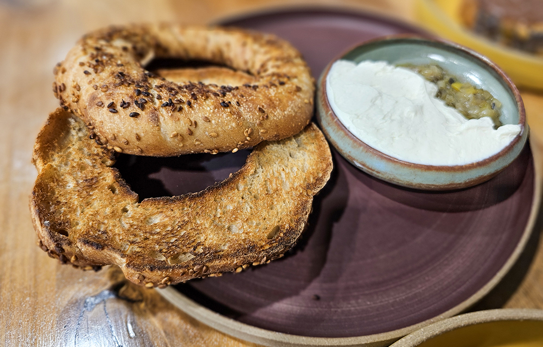 Simit, a Turkish cousin to the bagel, is served with charred leek confit and cream cheese at Quail & Condor in Healdsburg. (Heather Irwin/The Press Democrat)