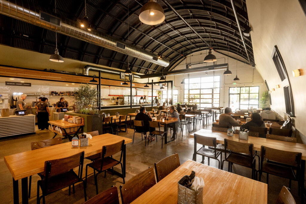 There’s plenty of seating on tables made from reclaimed wood from the lanes of a local bowling alley at the Stateline Road Smokehouse Friday, August 23, 2024 in Napa. (John Burgess / The Press Democrat)
