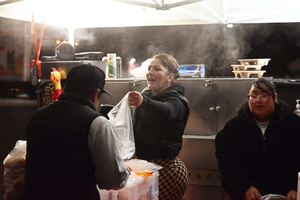 Janette Marroquin, center, and Dulce Peña serving up steaming hot tamales at Max’s Tamales stand located in the parking lot at 565 Sebastopol Road in the Roseland neighborhood of Santa Rosa on Friday Nov. 8, 2024. (Erik Castro / For The Press Democrat)