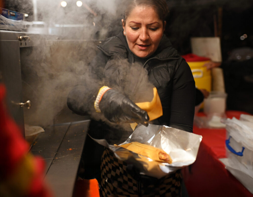 Janette Marroquin serving up streaming hot tamales at Max’s Tamales stand located in the parking lot at 565 Sebastopol Road in the Roseland neighborhood of Santa Rosa on Friday Nov. 8, 2024. (Erik Castro / For The Press Democrat)