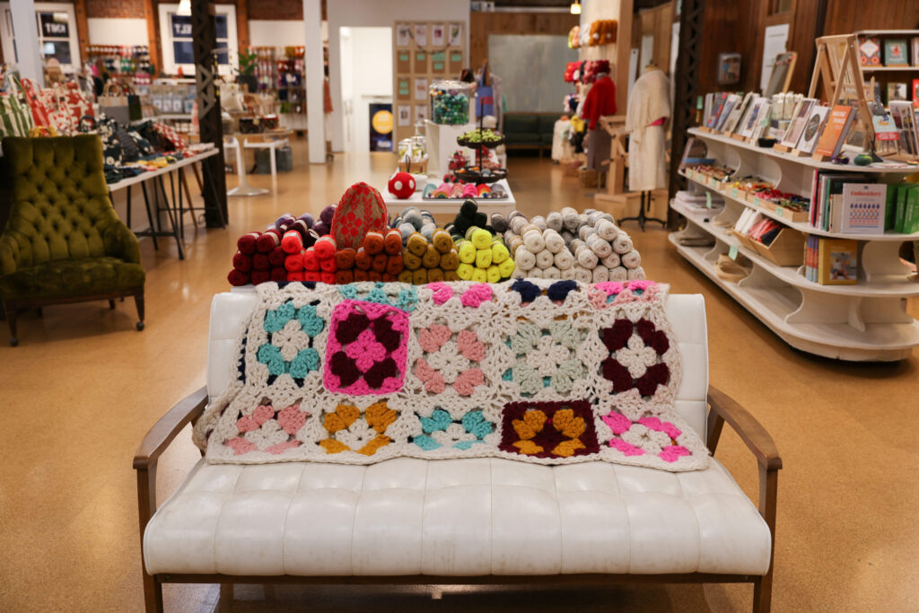 A couch with a blanket adds to the warmth of Castaway Yarn in Santa Rosa on Thursday, November 20, 2025. (Christopher Chung/The Press Democrat)