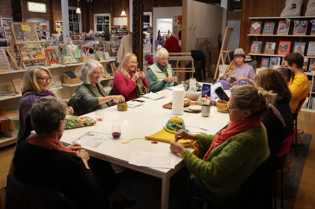 A group of women knit while socializing during a Thursday Knit Night at Cast Away Yarn in Santa Rosa on Thursday, November 20, 2025. (Christopher Chung/The Press Democrat)