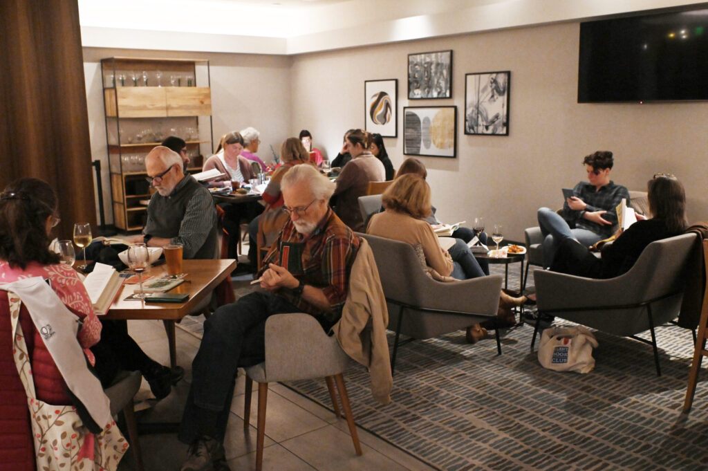 Attendees during a meeting of the Silent Book Club held at AC Lounge in Santa Rosa on Wednesday, Dec. 11, 2024. (Erik Castro / For The Press Democrat)
