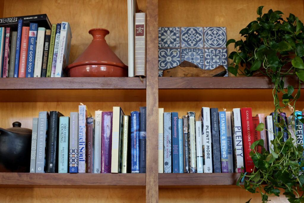 A variety of cookbooks sit on shelves above the bar at Pearl Petaluma in Petaluma Thursday, Jan. 8, 2026. (Beth Schlanker / The Press-Democrat)