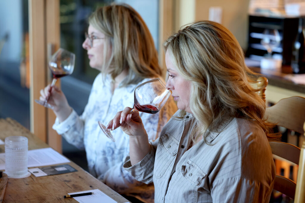 Guest Shawna Keech, right, and Christina Ferrari, rear, sample Pinot Noir at Halleck Vineyard in Sebastopol Thursday, Jan. 15, 2026. (Beth Schlanker / The Press Democrat)