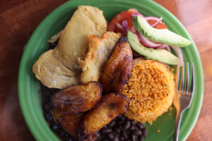 The Pollo al Horno featuring chicken, black beans, rice, and plantains at El Coqui Puerto Rican Cuisine in Santa Rosa Sunday, Jan. 18, 2026. (Beth Schlanker / The Press Democrat)