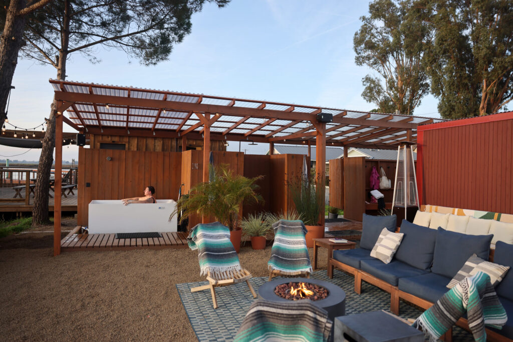 Khephra Molloy sits in a cold plunge tub at Sundrop Sauna in Petaluma Sunday, Nov. 30, 2025. (Beth Schlanker / The Press Democrat)