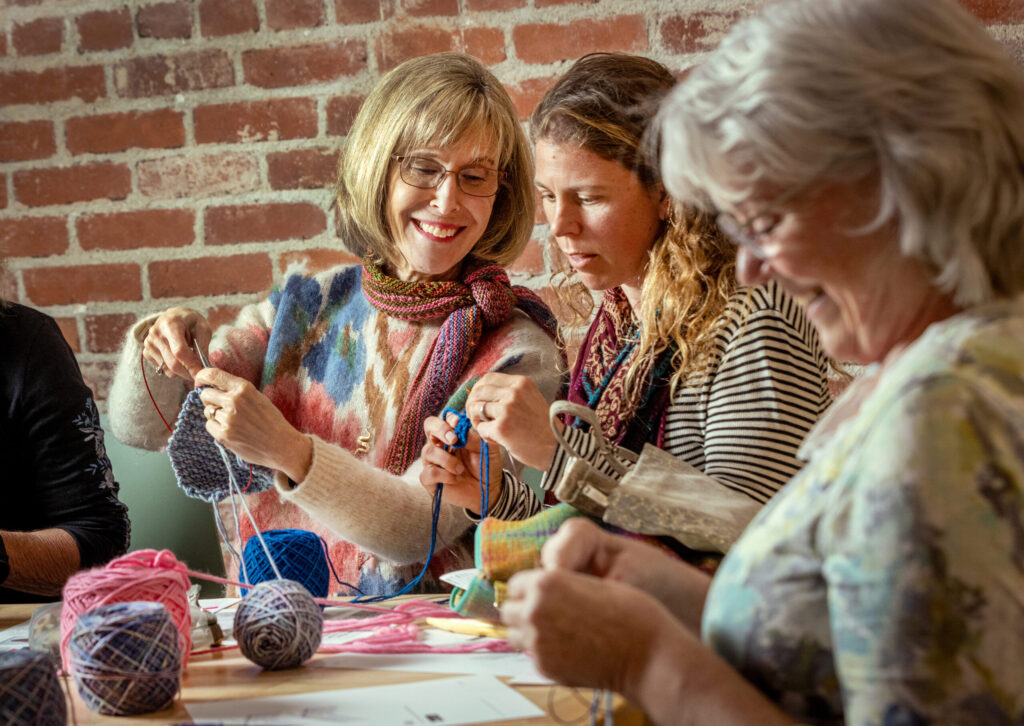 Instructor Pam Marshall, left, shows Daisy Wurtz how to create the pattern used to make a pair of felted slippers during a class Tuesday Dec. 2, 2025 at Gather in Sebastopol. (John Burgess / The Press Democrat)