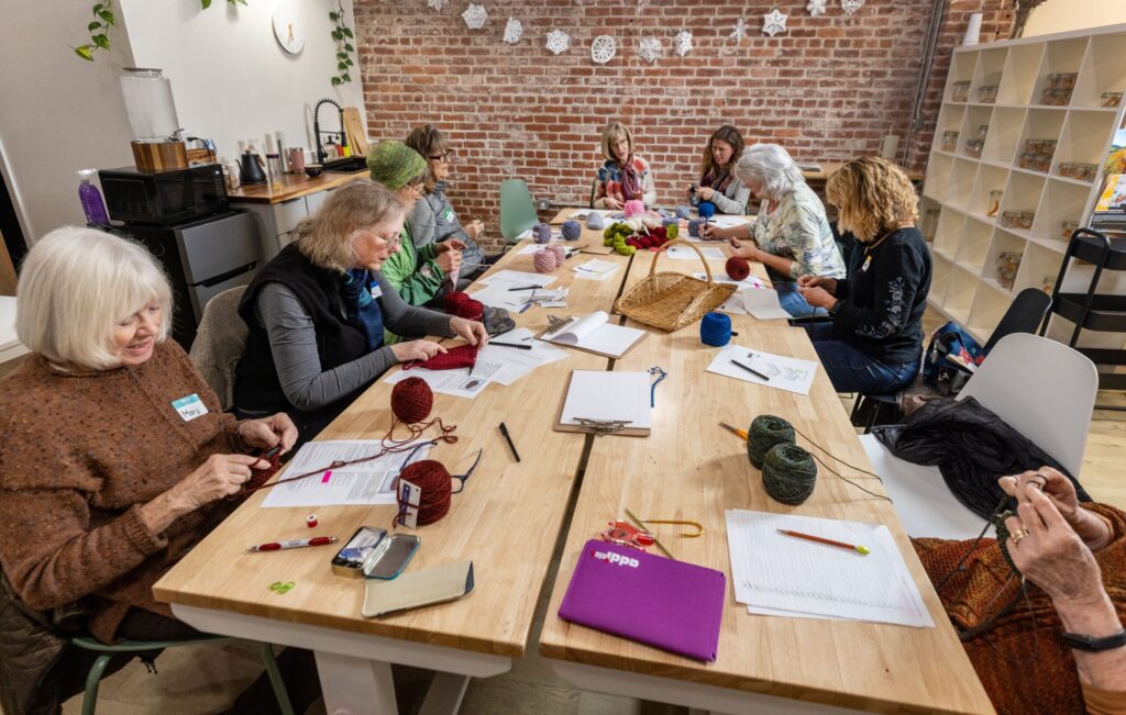 People practice knitting during a class Tuesday, Dec. 2, 2025 at Gather in Sebastopol. (John Burgess / The Press Democrat)