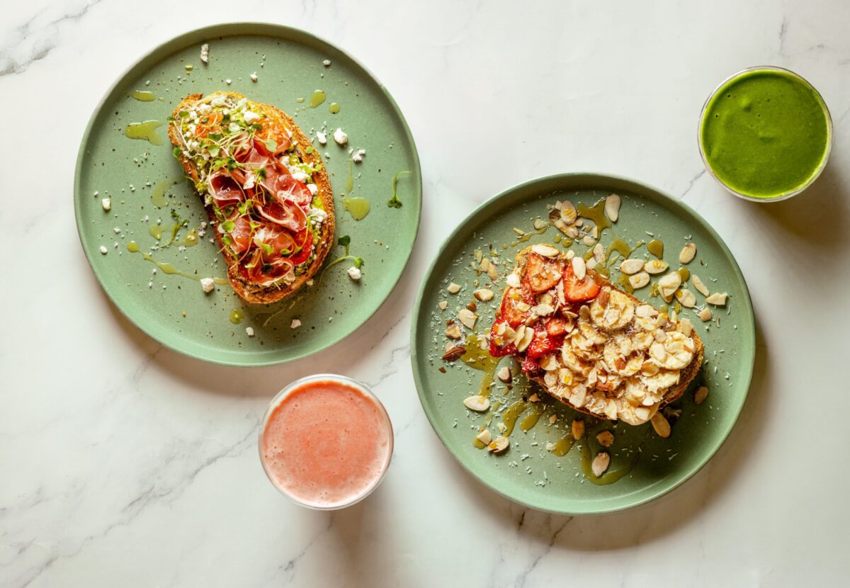 From left, avocado toast topped with prosciutto and sprouts, and the Sweet Crunch toast with almond butter, bananas, strawberries, coconut and almonds from Succo Cold-Pressed in Santa Rosa. (John Burgess / The Press Democrat)