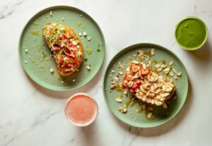 From left, avocado toast topped with prosciutto and sprouts, and the Sweet Crunch toast with almond butter, bananas, strawberries, coconut and almonds from Succo Cold-Pressed in Santa Rosa. (John Burgess / The Press Democrat)