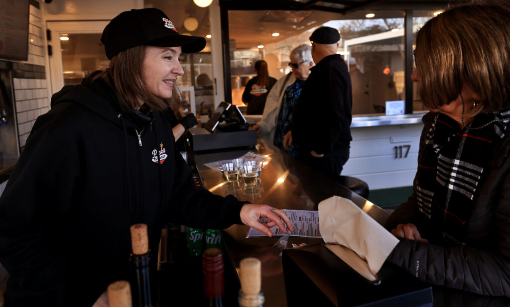 Amber Lanier, a fifth-generation Cloverdale resident and general manager of Pick’s Roadside, left, suggests a menu item as Pick’s opens, Saturday, Jan. 10, 2026. (Kent Porter / The Press Democrat)