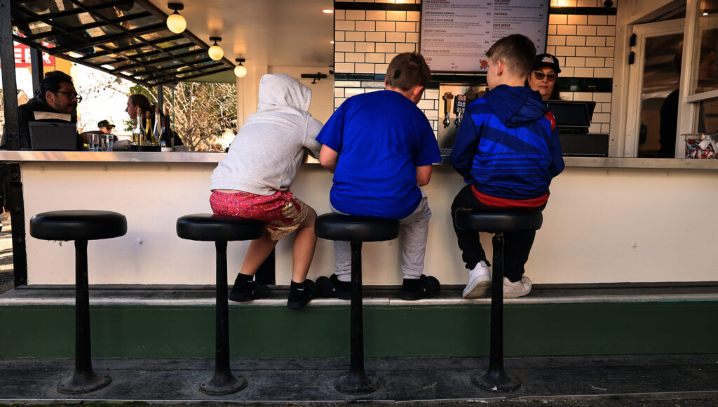 From left, friends Tucker Hollowell, Sonny Hendricks, and Johnny Miller wait for their orders Pick’s Roadside in Cloverdale Saturday, Jan. 10, 2026. (Kent Porter / The Press Democrat)