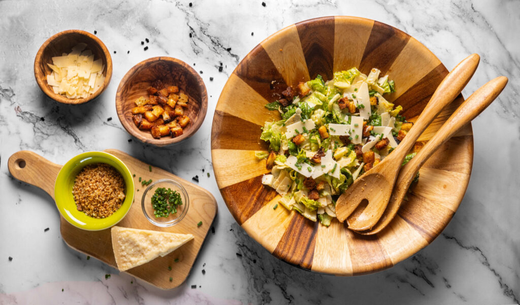 Andrew Whiting, owner of Hot Drops hot sauce and recent finalists on Gordon Ramsay's Food Stars, uses his premium facto-fermented Fres-Yes sauce in his Ceasar Salad dressing Wednesday, August 7, 2024 in Santa Rosa. (John Burgess/The Press Democrat)