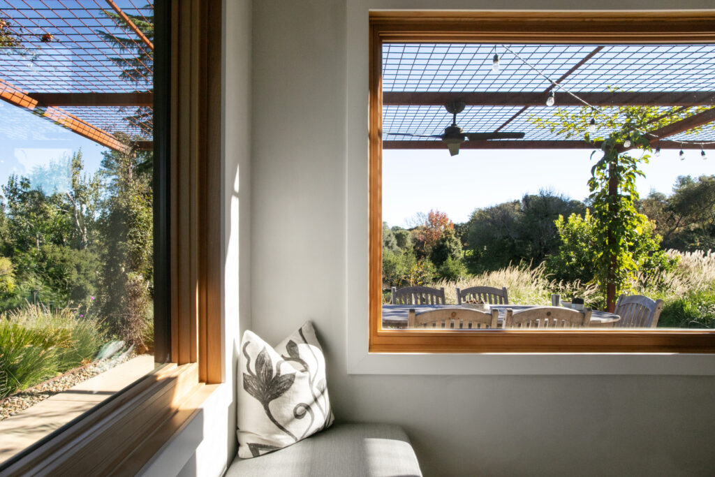 Two windows frame the dining nook to offer expansive views of the property. (Eileen Roche)