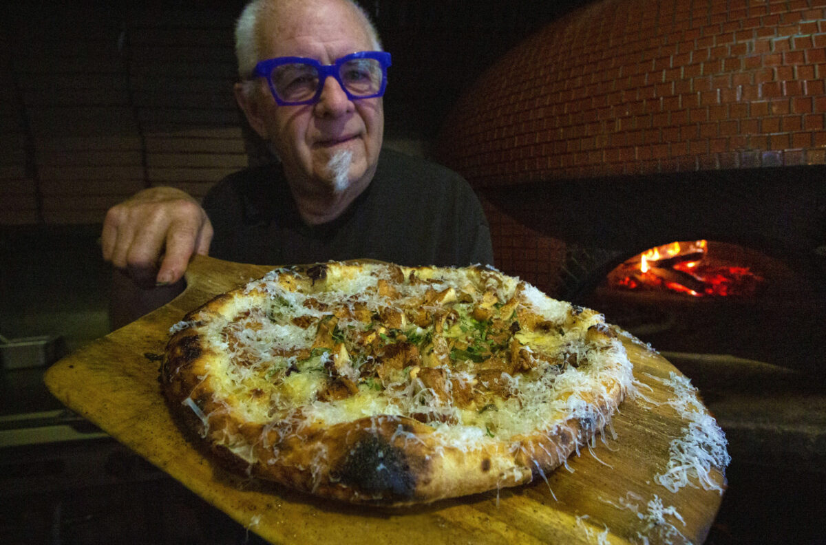 Rob Larman with a chanterelle mushroom pizza fresh out of the wood-fired oven topped with a dusting of parmesan cheese at his Il Fuoco restaurant on Highway 12 in Boyes Hot Springs. Photo taken on Monday, Nov. 6, 2023. (Robbi Pengelly/Index-Tribune)