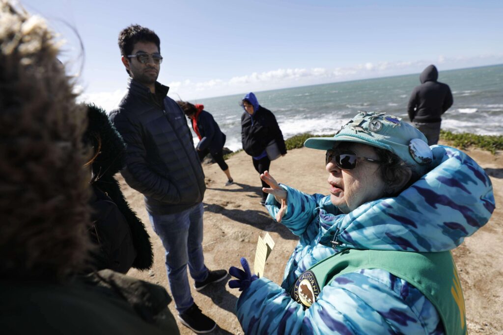 Norma Jellison, a docent with the Whale Watch Program run by Stewards of the Coast and Redwoods, talks with East Bay residents about Pacific Gray Whales at Bodega Head near Bodega Bay on Sunday, February 17, 2019. (Beth Schlanker / The Press Democrat, file)