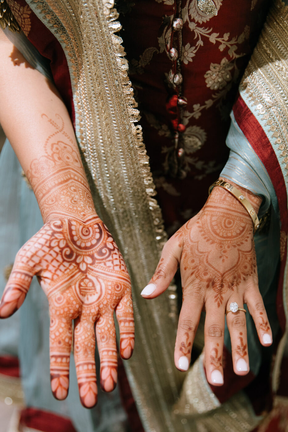 Sanjana and Evan's wedding included mehndi, with Sanjana receiving henna tattoos symbolizing her journey. (Katie Miller)