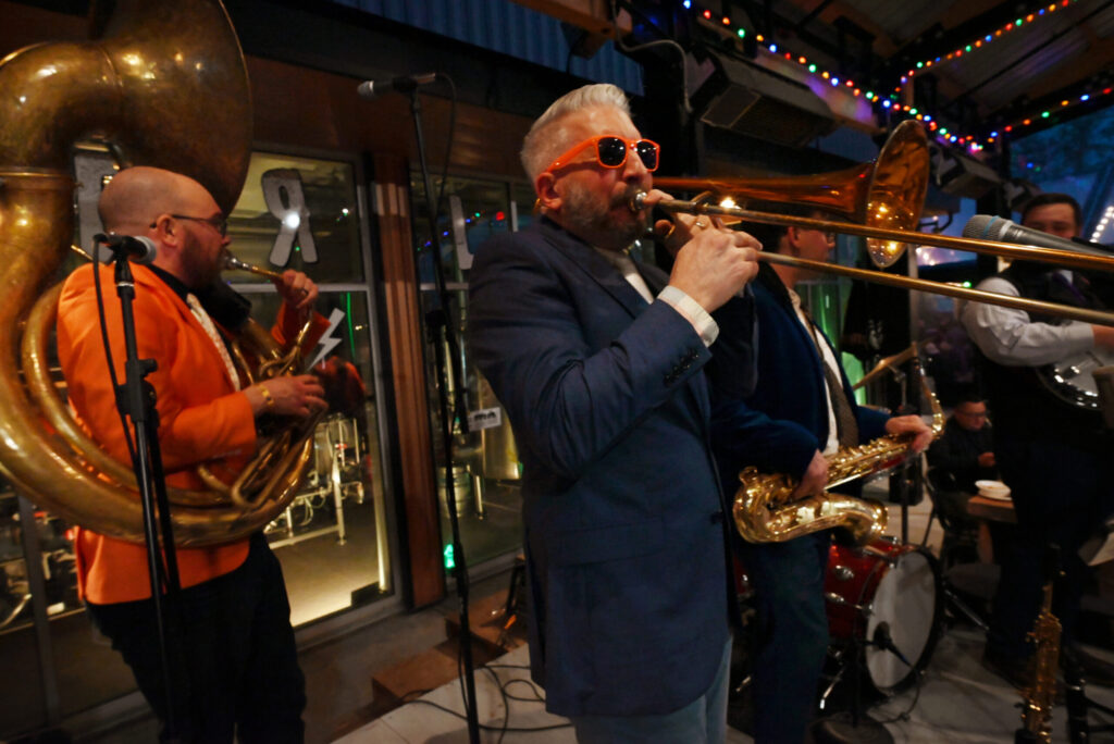Nick Pulley, left, on the sousaphone and Jason Thor on the trombone along with fellow members of The King Street Giants perform during the Petaluma Music Festival's 11th annual Mardi Gras Party at Lagunitas Brewing Co. Taproom and Sanctuary in Petaluma Tuesday, March 4, 2025. (Erik Castro / For The Press Democrat)