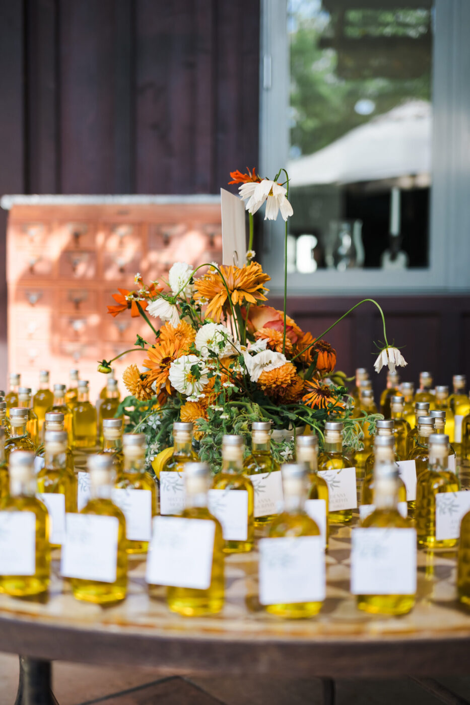 As Olivia and Brooks' wedding came to a close, the couple sent guests home with bottles of olive oil sourced from the trees at Olivia’s childhood home. (Katie Monroe)