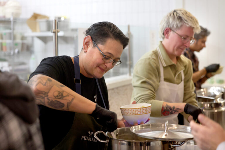 Chefs Leah Scurto, left, and Dany Cleland, right, serve soup during the Queer Soup Night event at Slow Co. Pizza in Cotati Sunday, Nov. 23, 2025. (Beth Schlanker / The Press Democrat)