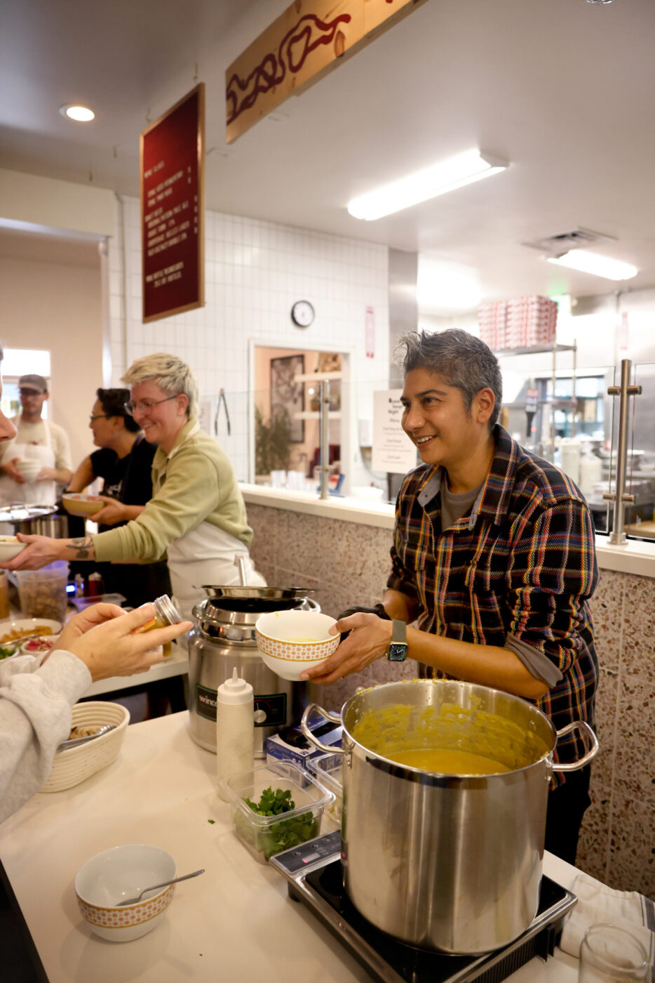 Chef Preeti Mistry serves up a butternut squash dal soup during the Queer Soup Night event at Slow Co. Pizza in Cotati Sunday, Nov. 23, 2025. (Beth Schlanker / The Press Democrat)