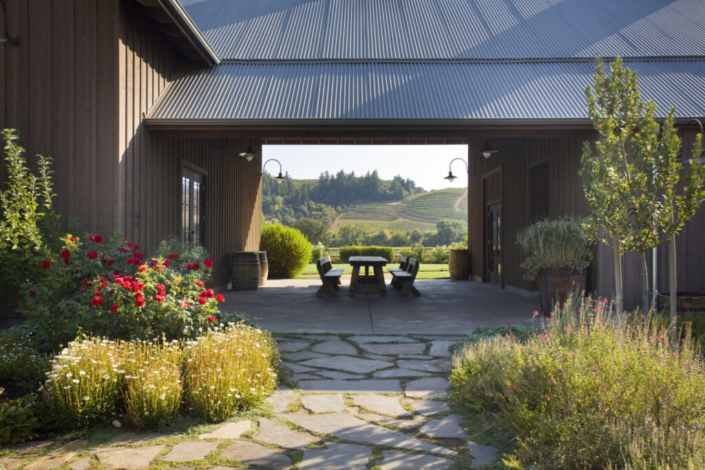 At Dutcher Crossing Winery in Geyserville, vineyard-facing tables sit in a covered breezeway, beneath a pergola, on a paved patio and alongside a pétanque court. Wine Country doesn’t get much prettier than this. (M. J. Wickham)