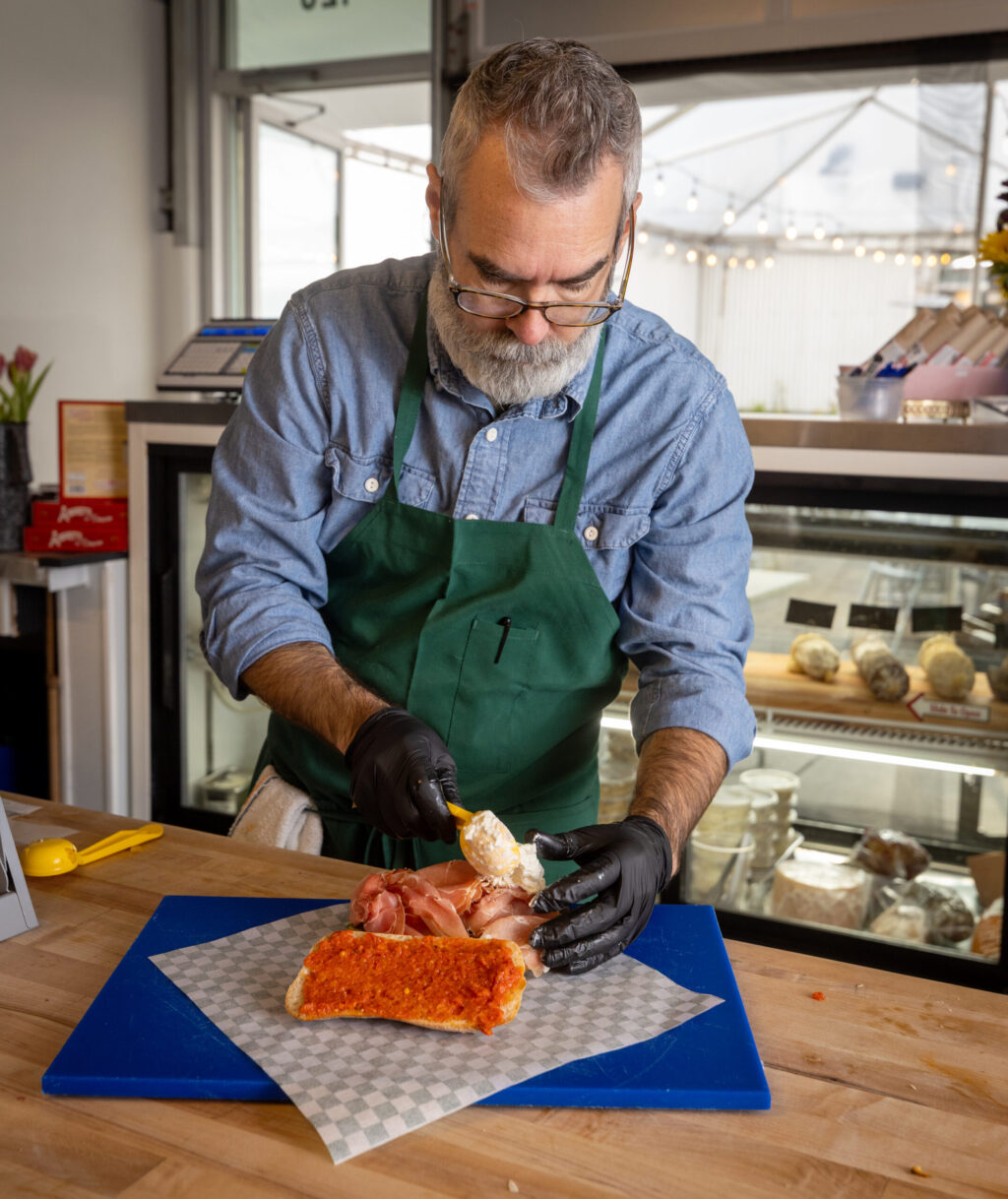 Thomas James makes the signature Genero’s sandwich from Genero’s Deli Friday, Jan. 30, 2026 in Sebastopol’s Barlow district. (John Burgess/The Press Democrat)