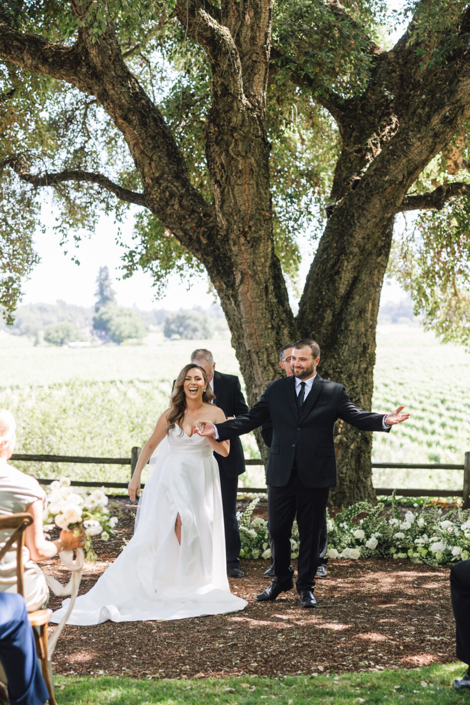 The couple exchanged vows beneath the cool shade of a majestic oak tree. (Ashley Carlascio)