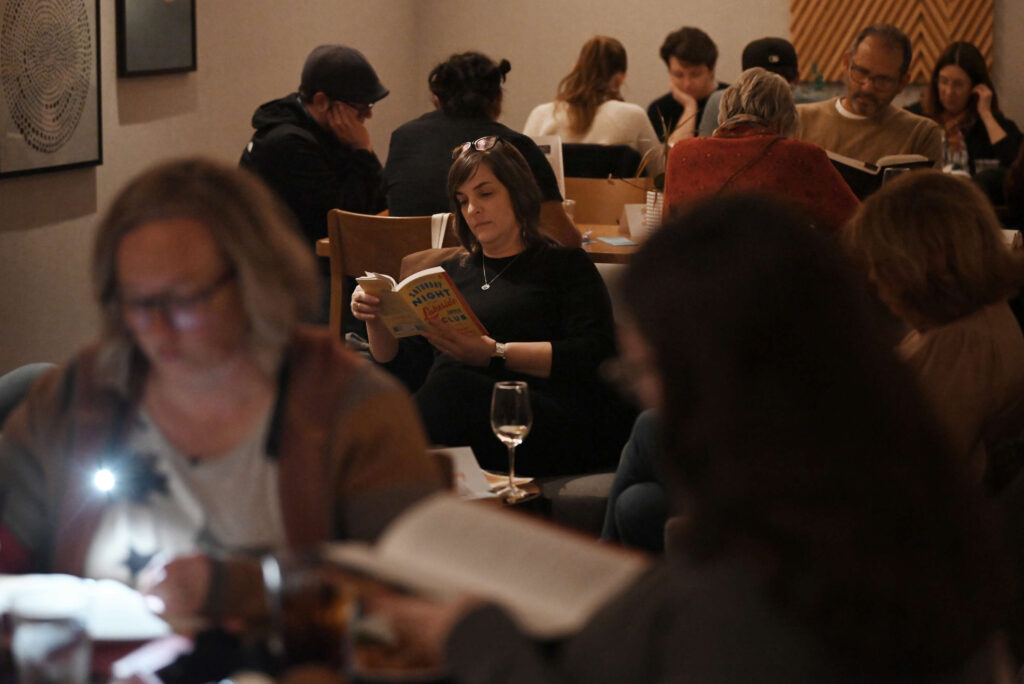 Amanda Janik, center, founder of the Santa Rosa chapter of the Silent Book Club which was held at AC Lounge in Santa Rosa on Wednesday, Dec. 11, 2024. (Erik Castro / For The Press Democrat)
