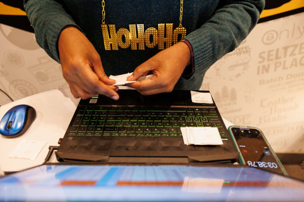 Trey Hart looks through different answers to see which ones are correct during the Redwood Empire Food Bank’s Trivia Night at Barrel Brothers Brewing Kitchen & Cocktails in Windsor on Thursday, Dec. 14, 2023. (Abraham Fuentes / For The Press Democrat)