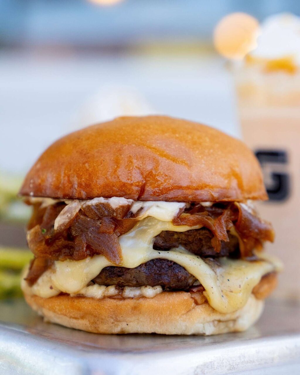 The anniversary burger from Gott’s Roadside features double-stacked beef patties topped with Gruyere, caramelized onions and garlic mayo on their signature toasted egg bun. (Courtesy of Gott's Roadside)