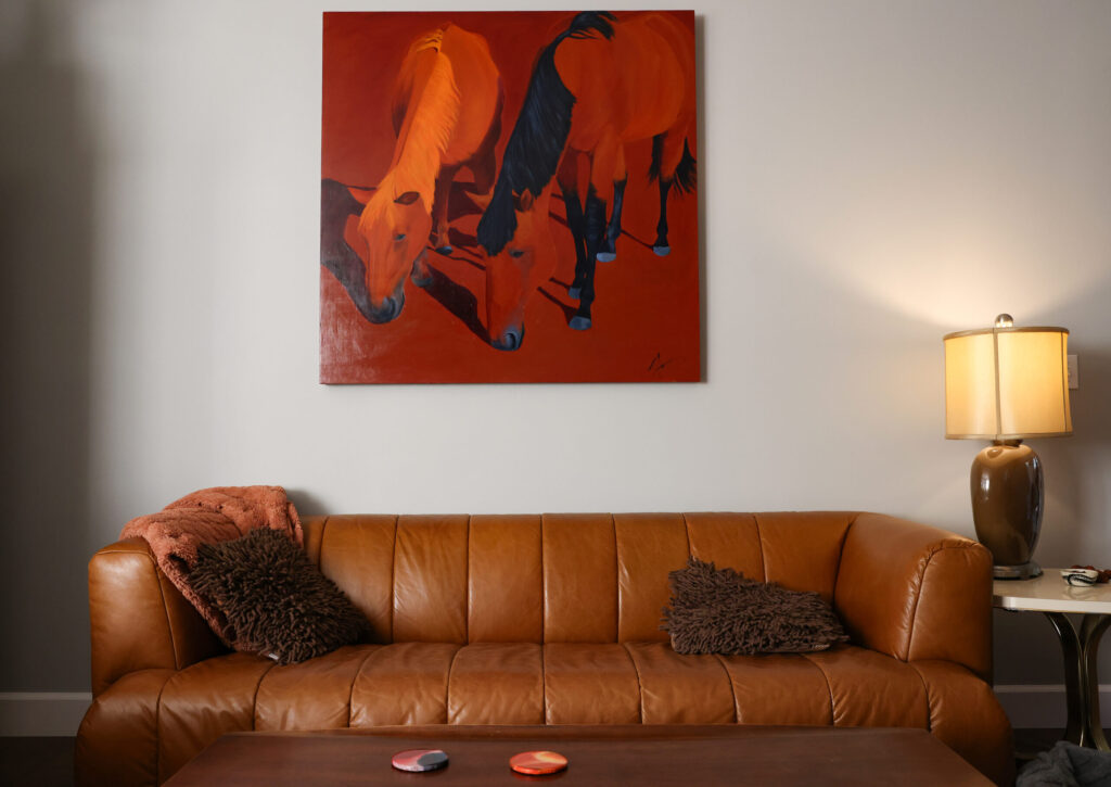 A painting of horses by Stacia Brady, Ada Limón’s mother, hangs above the living room couch at her home in Glen Ellen on Wednesday, February 4, 2026. (Christopher Chung/The Press Democrat)